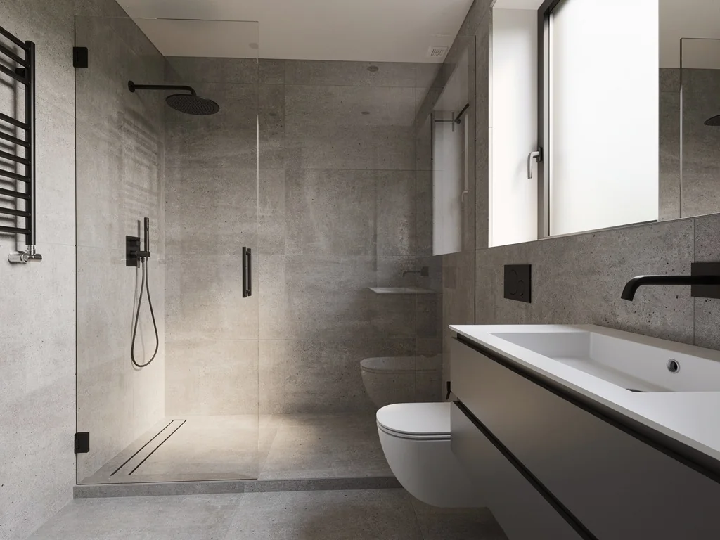 Douche à l'italienne et sol en carrelage effet béton après rénovation